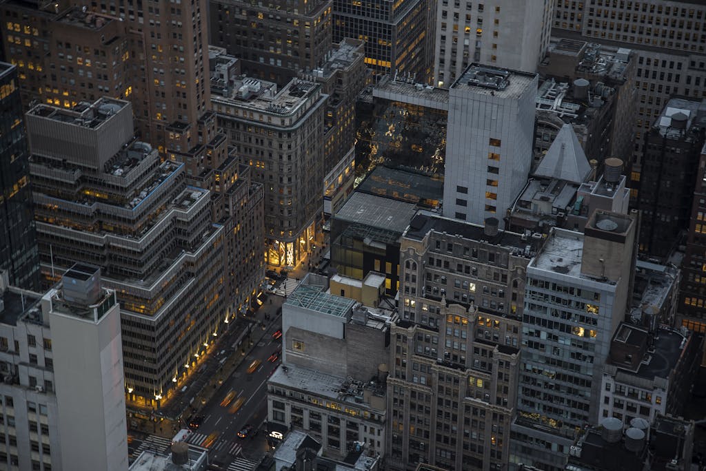 Tri Town News Sidney NY Obituaries of illuminated skyscrapers in Manhattan, New York City, showcasing urban architecture and city life at night.