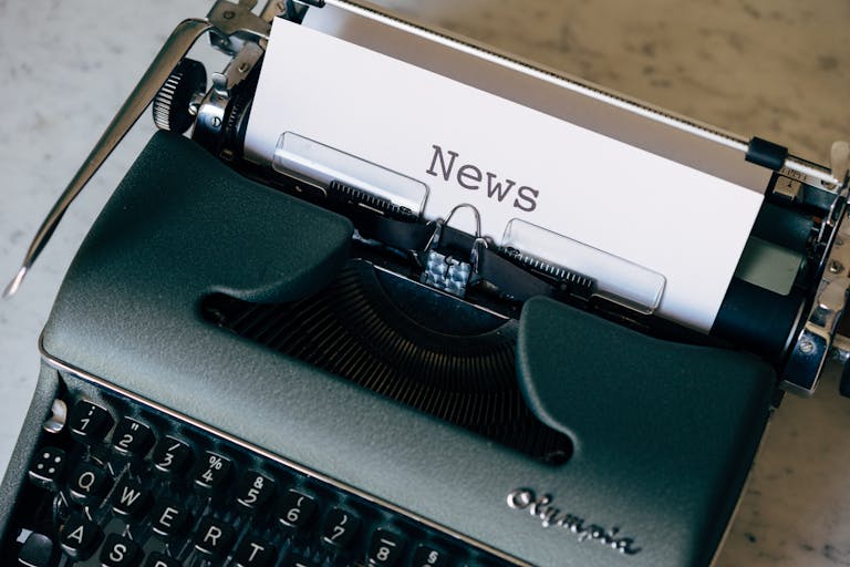 Get Fast Release News on IPSA vintage typewriter with a paper titled 'News', symbolizing journalism and communication.