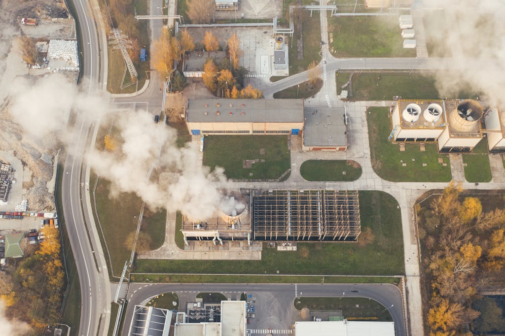 Global South Climate Change Impacts industrial area with visible smoke emissions in Poznań, Poland.