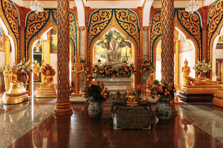 Biotox gold price in india temple interior showcasing golden Buddha statues and intricate designs in Phuket, Thailand.