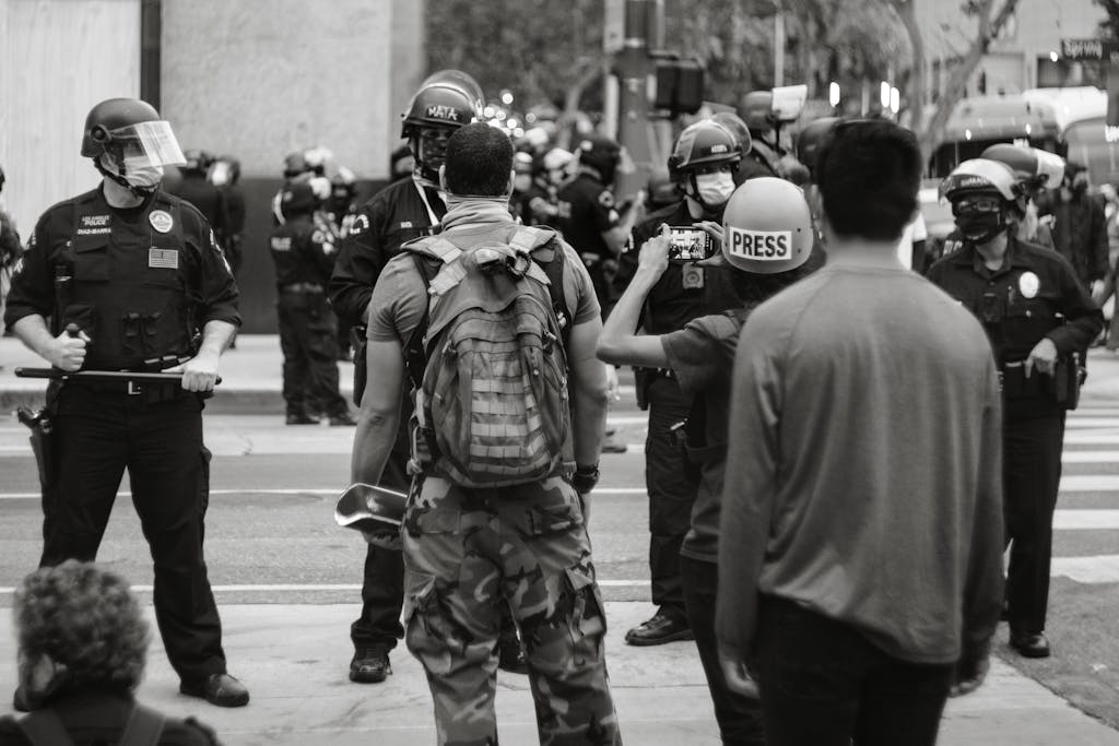 USA Press Release Black and white photo of protesters and police in Los Angeles during a rally.