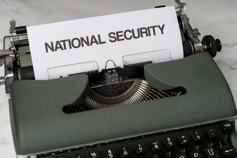 Ukrian vs Japan War Press Release Close-up of a vintage typewriter with a paper marked 'National Security', symbolizing confidentiality.