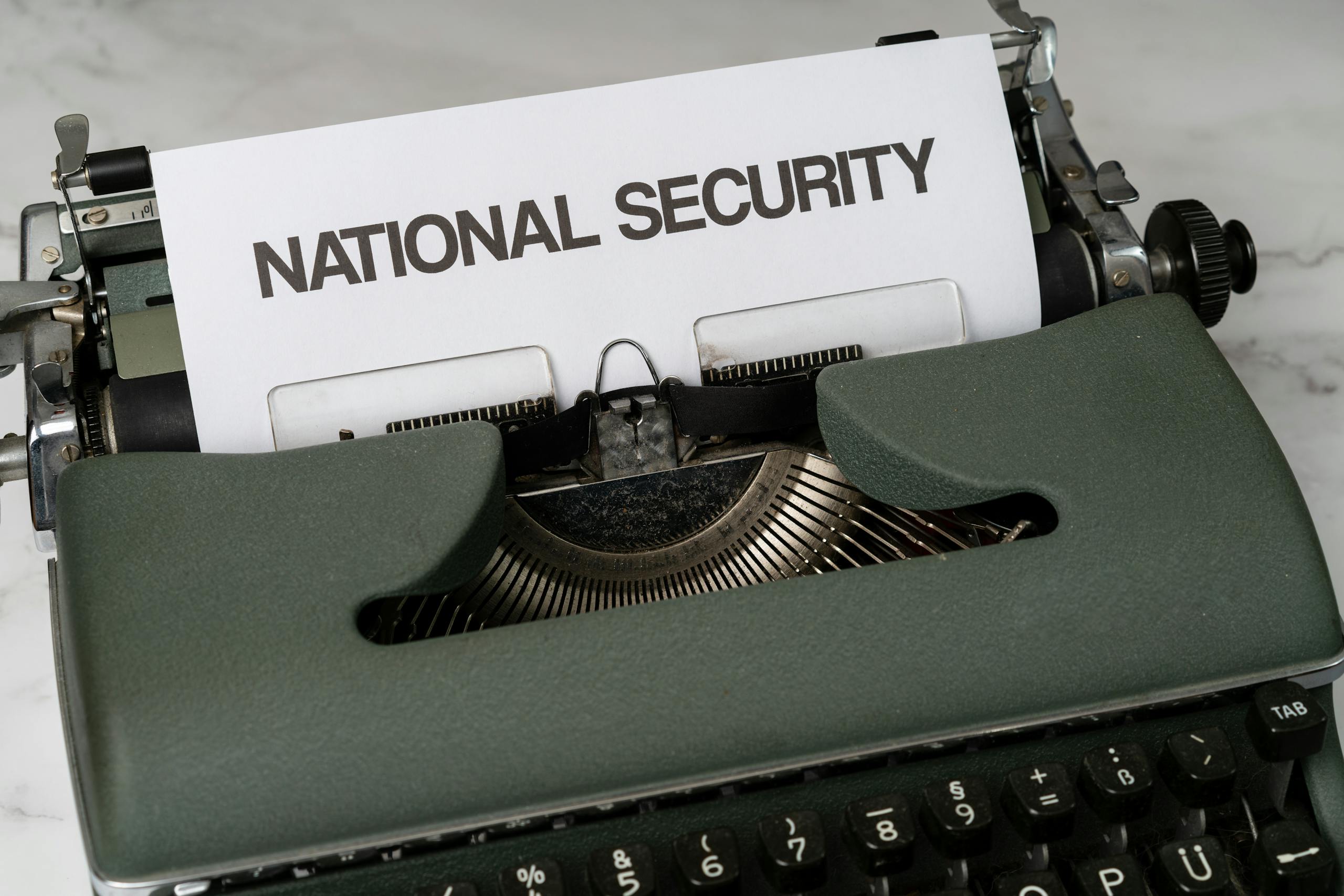 Ukrian vs Japan War Press Release Close-up of a vintage typewriter with a paper marked 'National Security', symbolizing confidentiality.