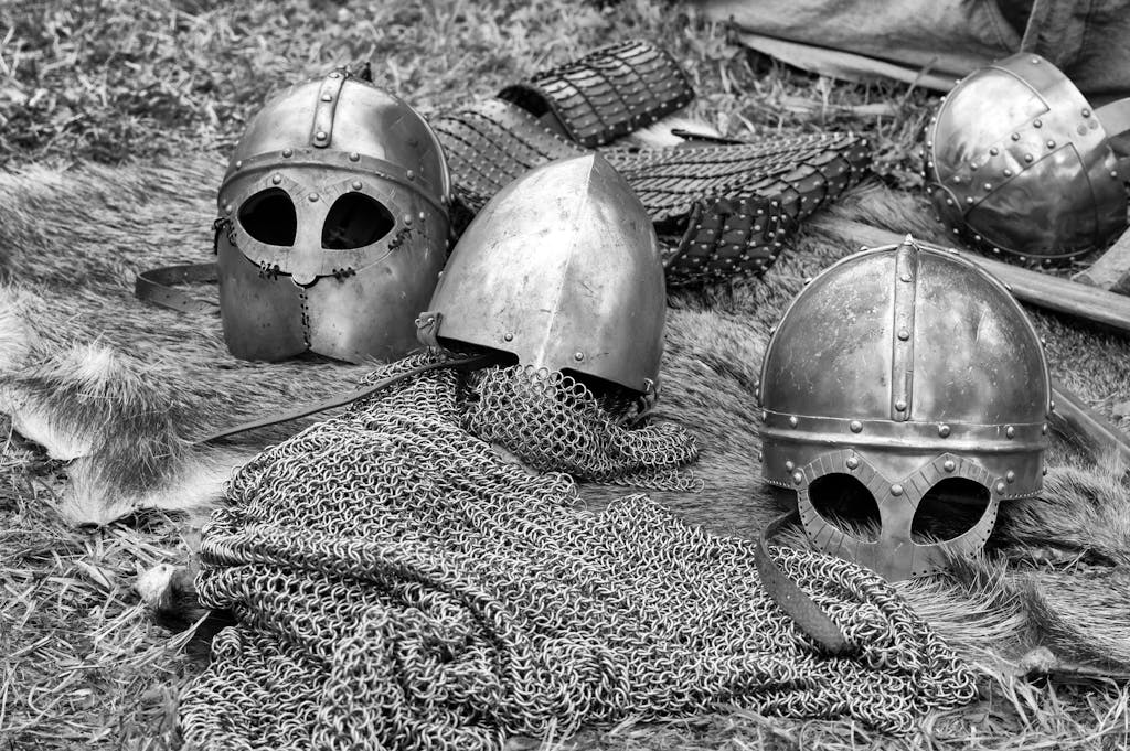 Startup or World War Close-up of historical medieval helmets and armor in black and white.