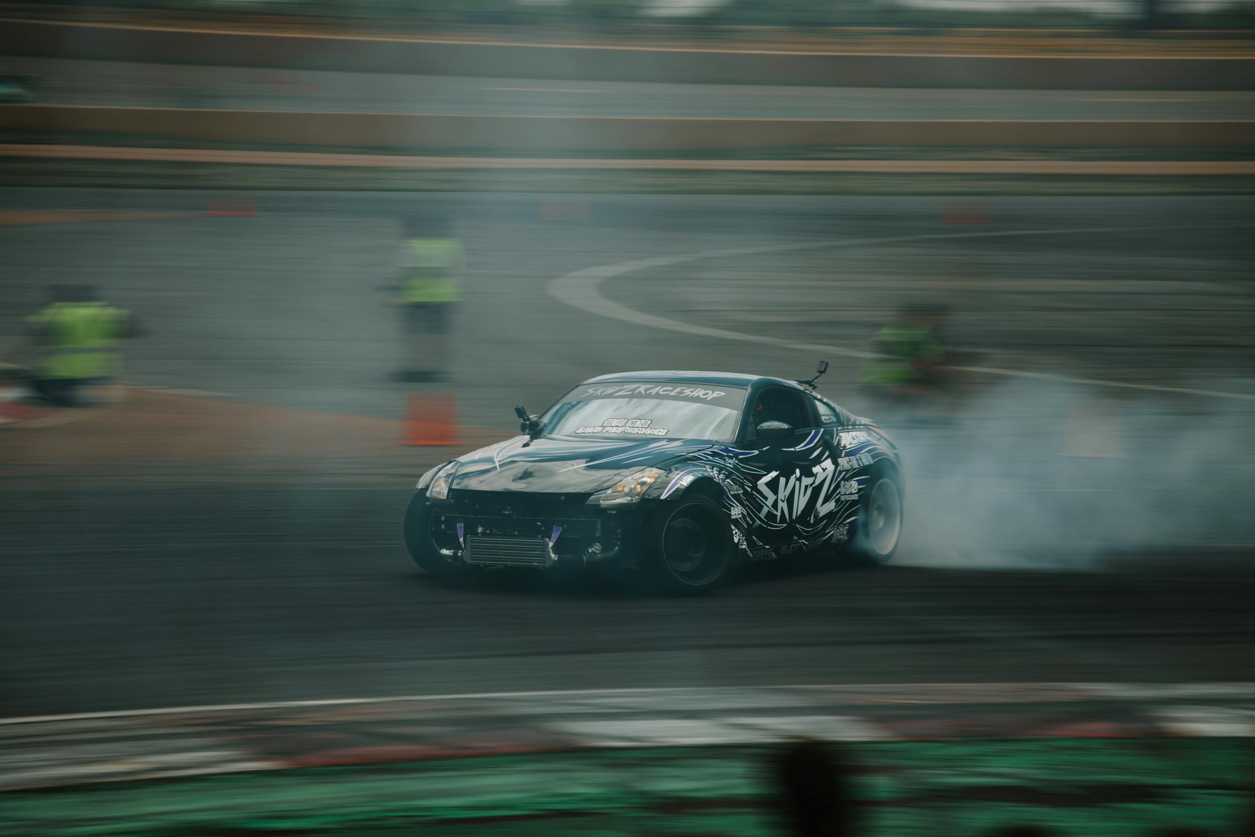 2004 Nissan 350Z Coilovers drift racing action captured with a Nissan car at a race track in Colorado, USA.