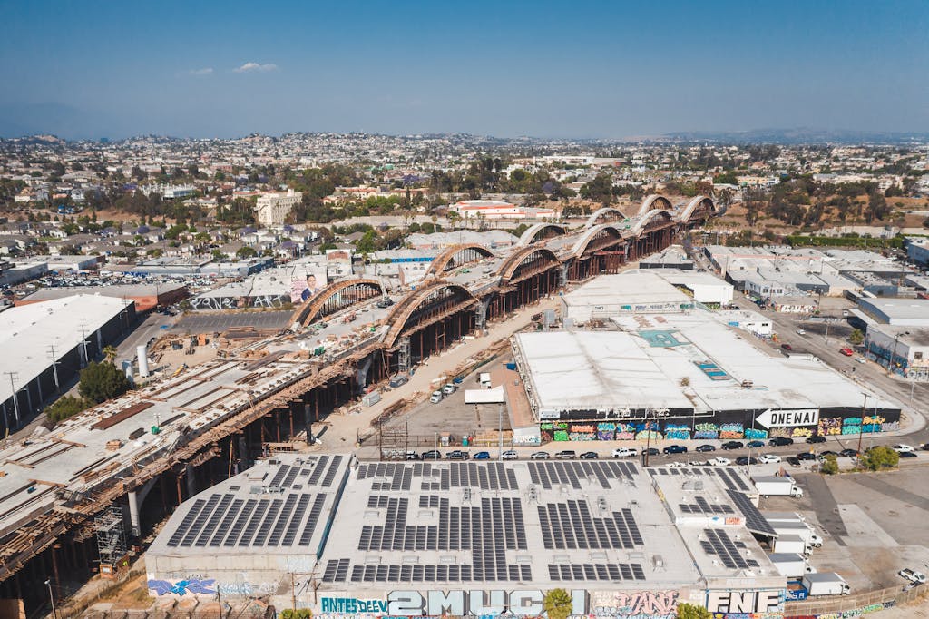 Explore this aerial view of solar panels and construction amidst the urban landscape of Los Angeles.