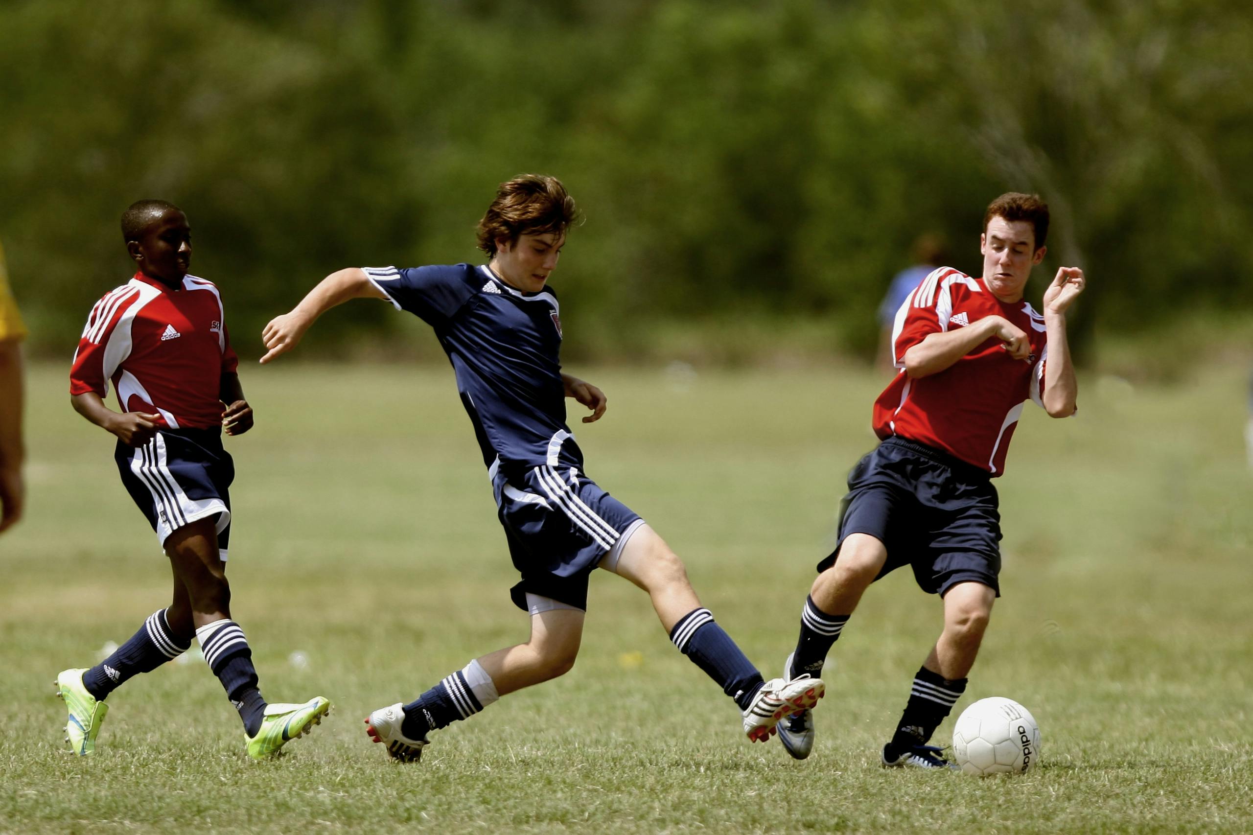 Israil Attack on Flastin Hammas Teenage soccer players in action during an outdoor match showcasing skill and competition.