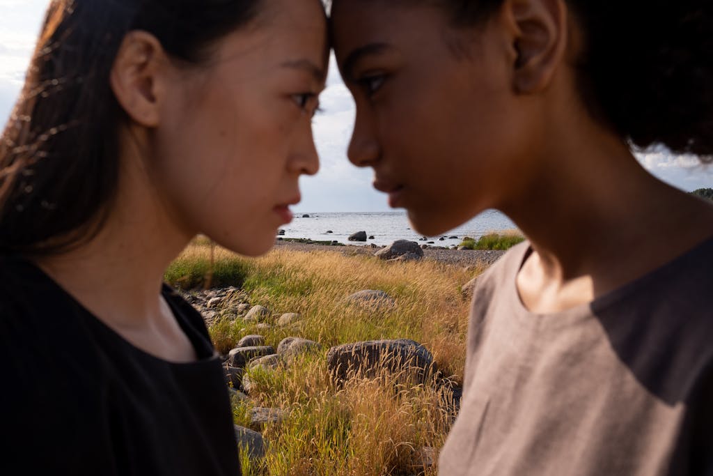 Ronaldo vs Messe in 2026: The Final Chapter of Football’s Greatest Rivalry Two women facing each other in a serene outdoor setting by the sea, emphasizing connection.