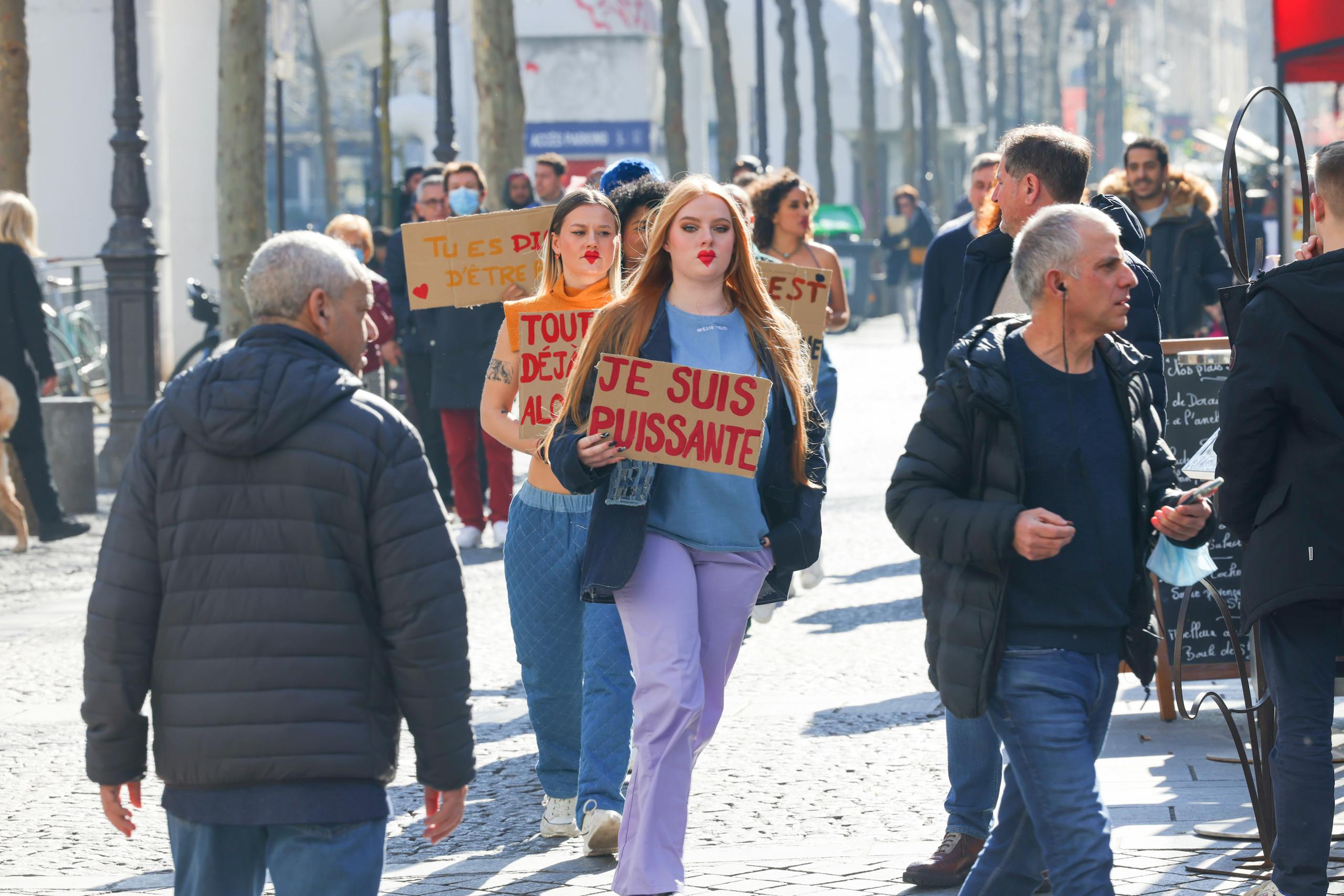 Civil Society Voices a city street holding signs in French, advocating for empowerment.