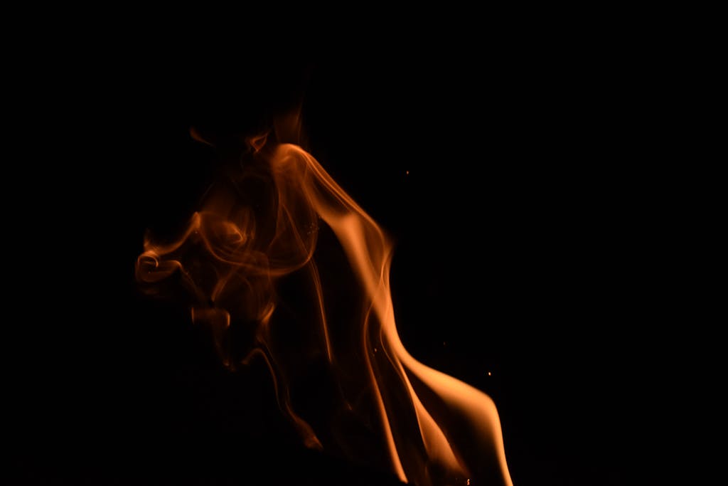 Sotwe A captivating capture of an orange flame against a dark background, creating a dramatic and artistic effect.
