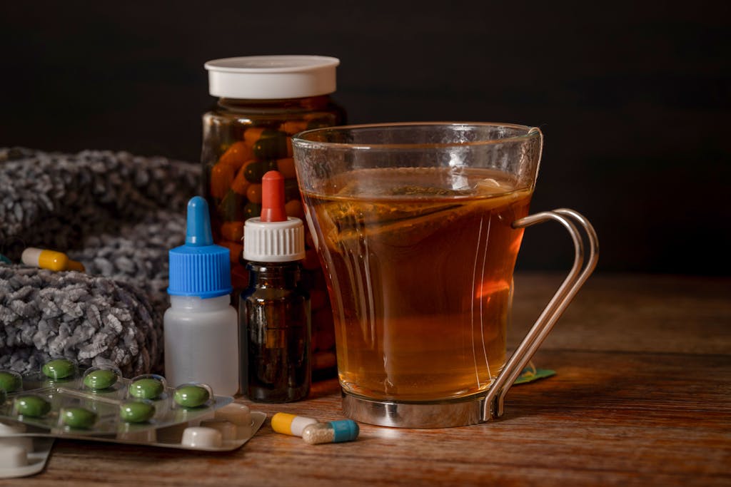Veganov Trichy A cup of herbal tea with medications suggests natural cold remedies for healing.