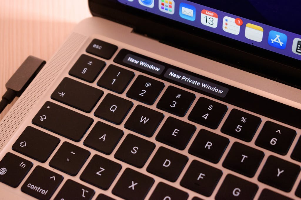 URLWO A detailed view of a laptop keyboard with browser tabs open, highlighting 'New Window' and 'New Private Window'.
