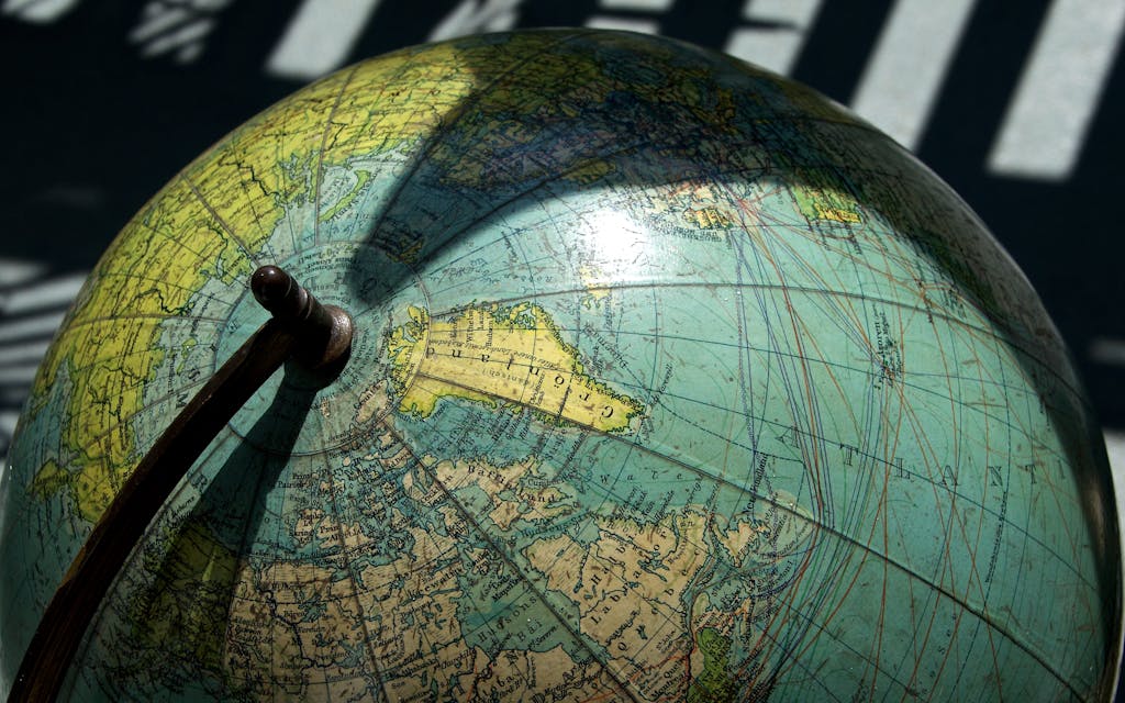 Buscrs A detailed vintage globe showcasing northern regions with visible longitude and latitude lines.