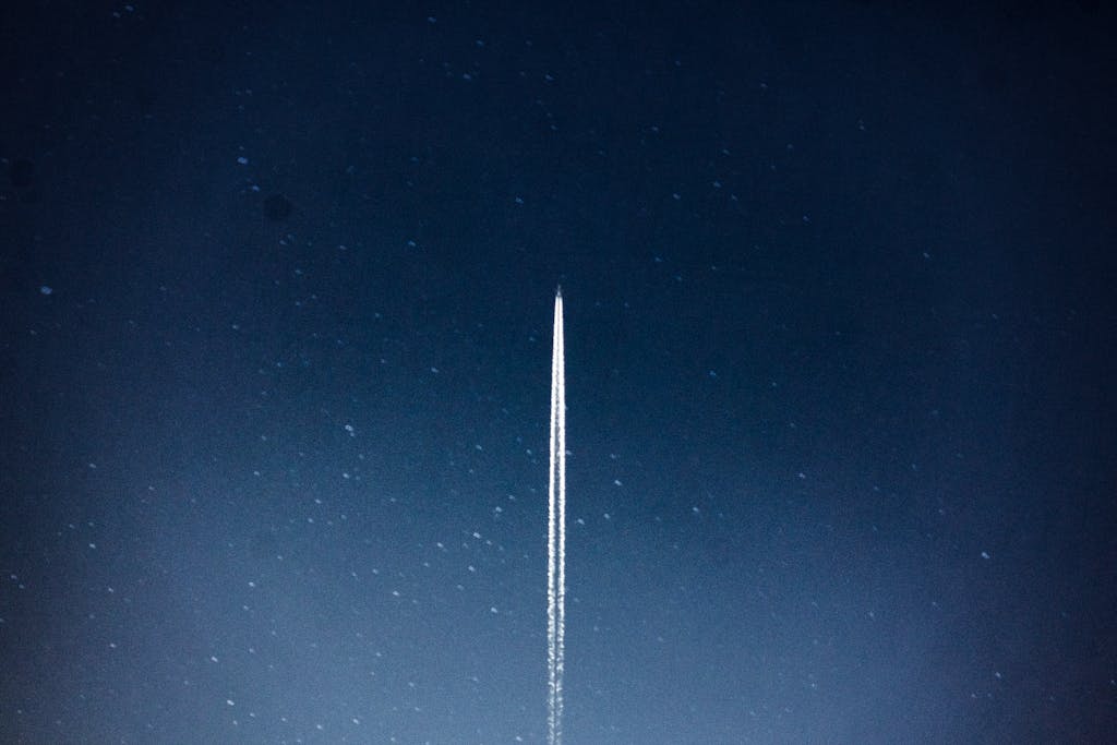 Darlnaija A rocket streaks through a starry night, leaving a trail in outer space.