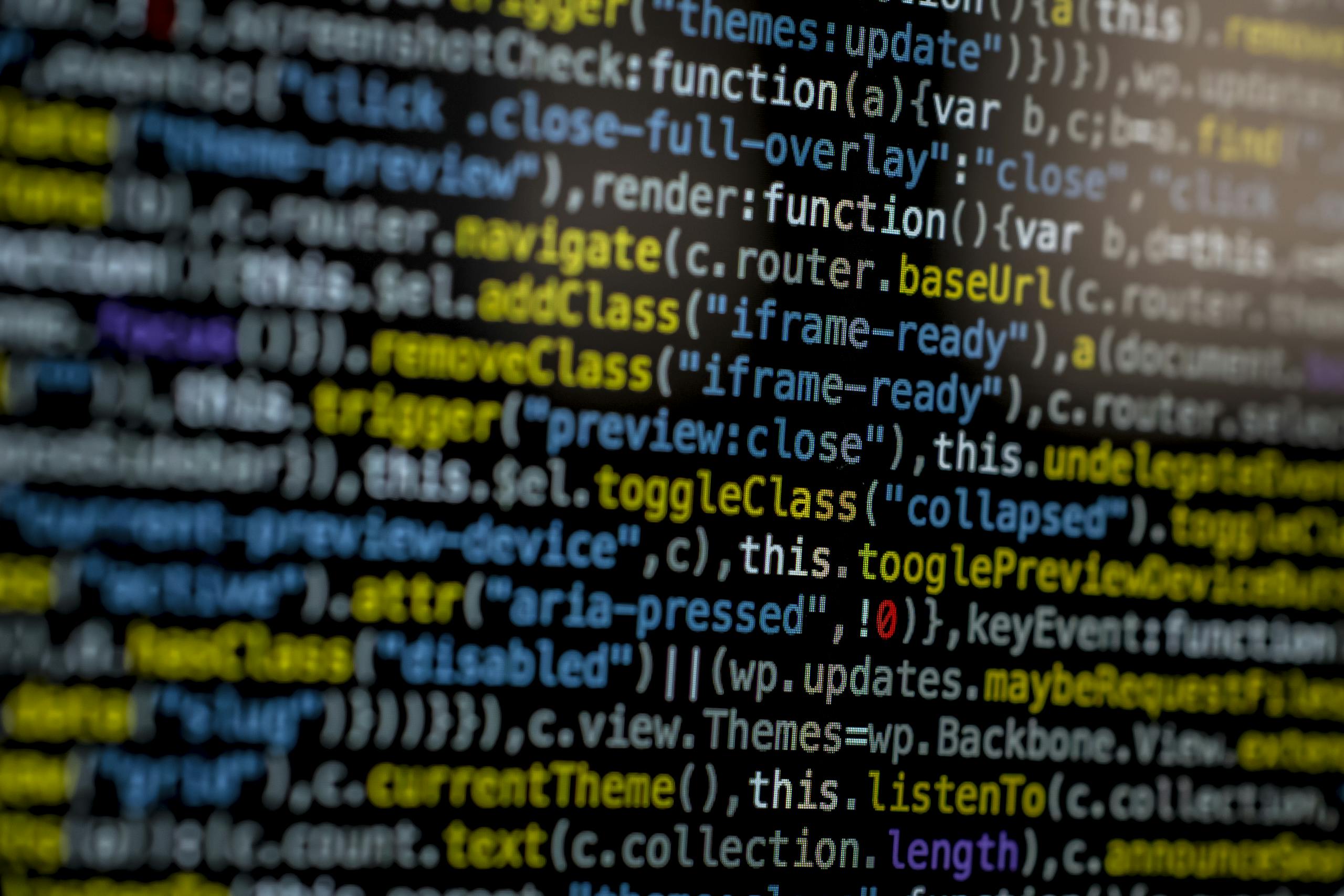 Mozarabic HoodieKnowledge Base Software An extreme close-up of colorful programming code on a computer screen, showcasing development and software debugging.