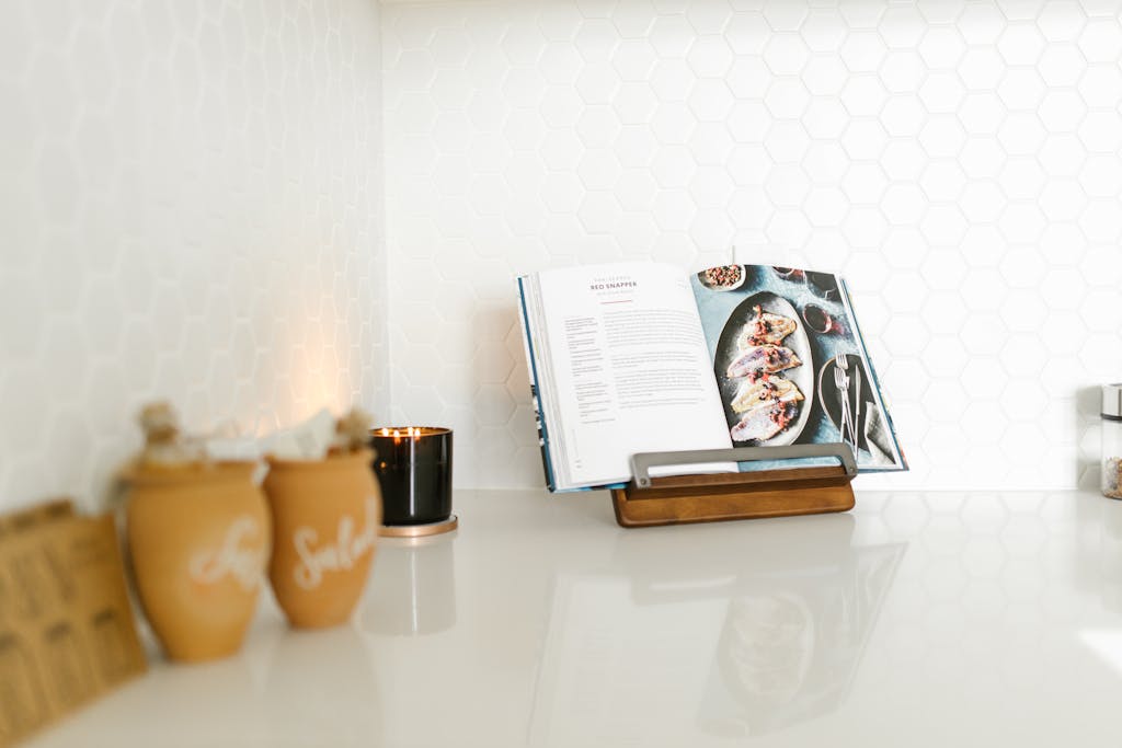 Recipeasy Recipes An open cookbook on a modern wooden stand in a stylish kitchen setting, perfect for culinary inspiration.