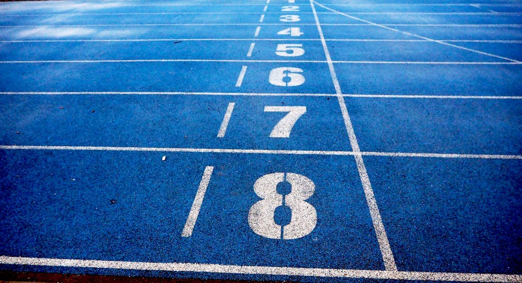 Runlia Blue athletic running track with numbered lanes, ideal for sports events and race preparations.