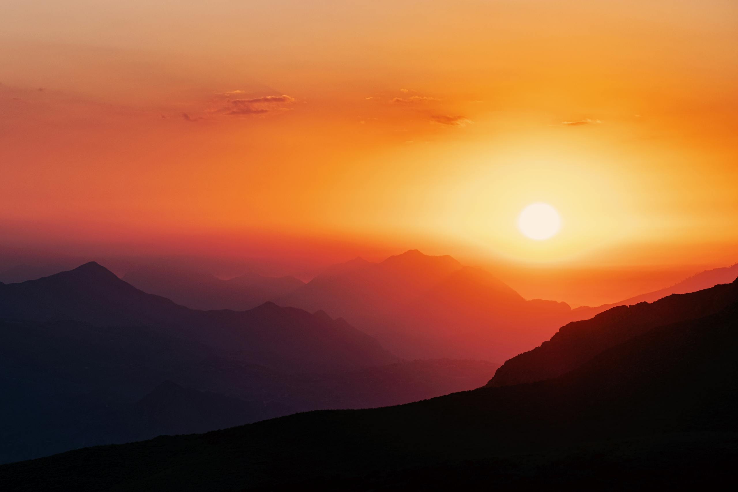 Mila Volovich Captivating view of sunset over the mountain range in Mila, Algeria, showcasing vivid colors.