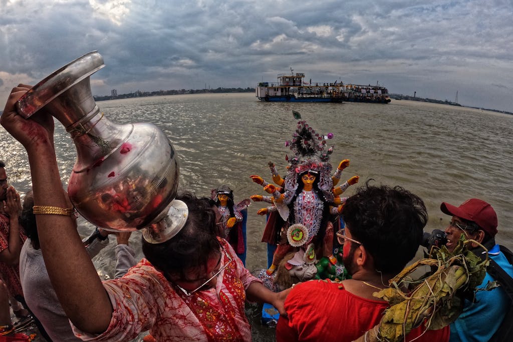 Robert Golob Capturing the colorful Durga Puja celebrations by the Ganges in Kolkata, India, with a focus on ritual and tradition.