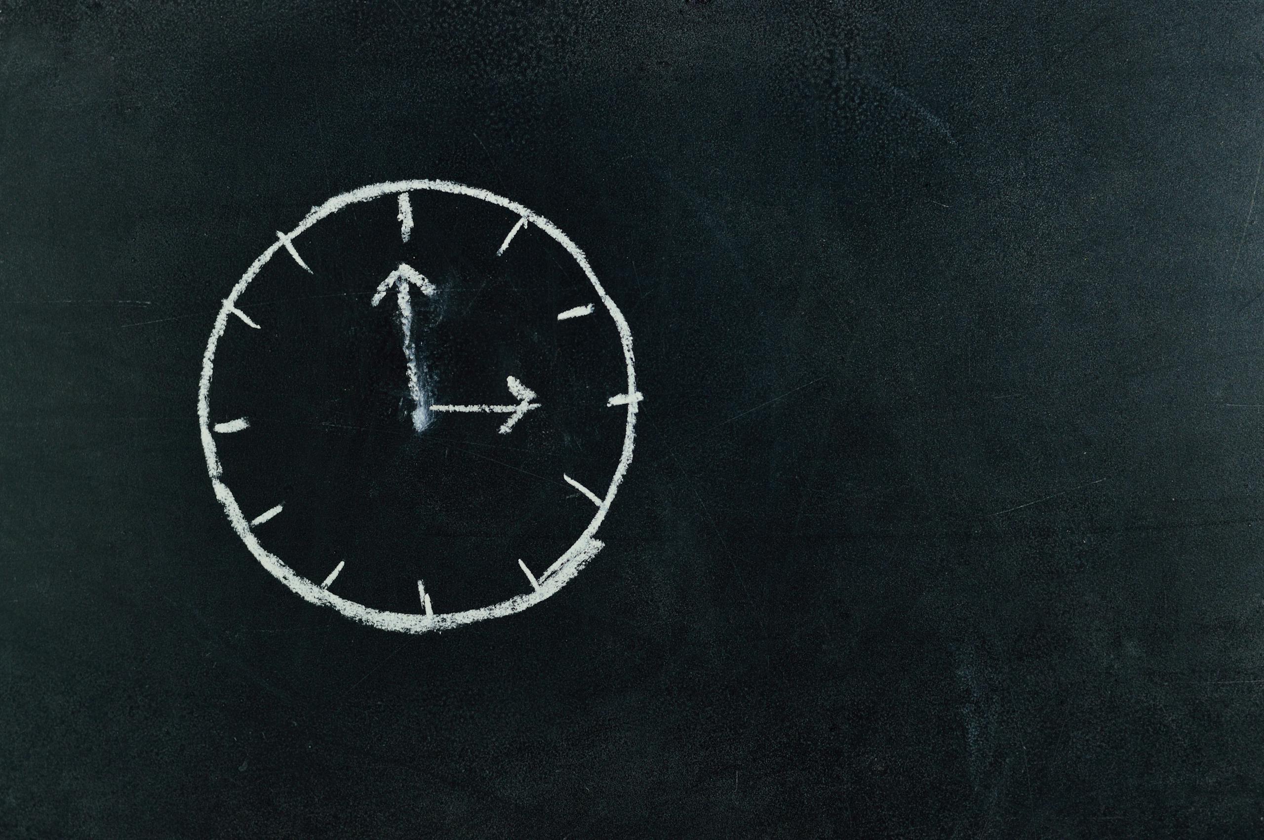 TimesNowNews Chalk-drawn clock on a blackboard, symbolizing time and education concepts.