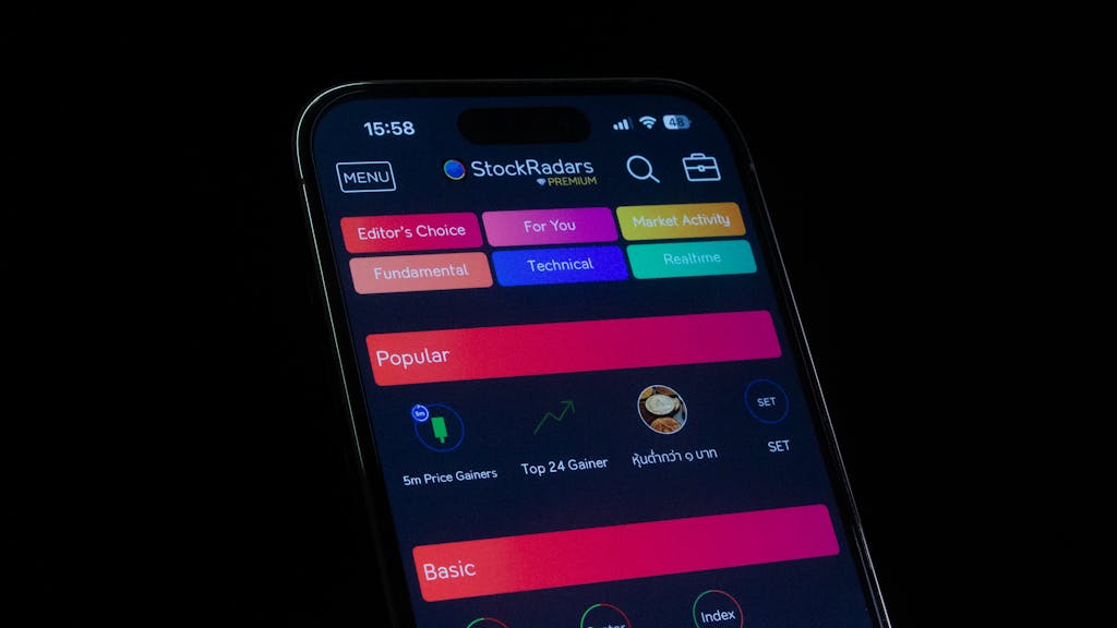 RN Fundamentals 2016 70 Questions Close-up of a smartphone displaying a financial stock trading app interface.