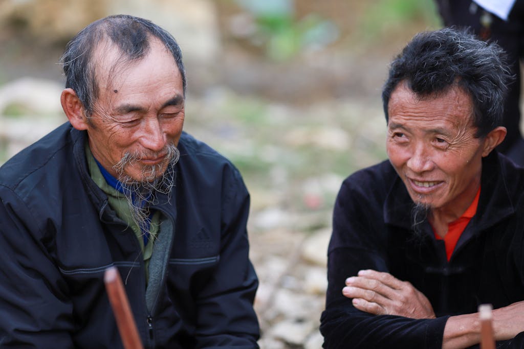 Naruto Senki Close-up of two elderly men from the Hmong community in Lào Cai, Vietnam, showcasing traditional life.