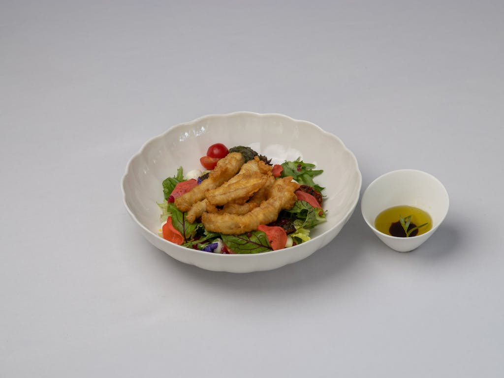 Calamariere Delicious calamari salad with a side of olive oil dressing in Bodrum, Türkiye.