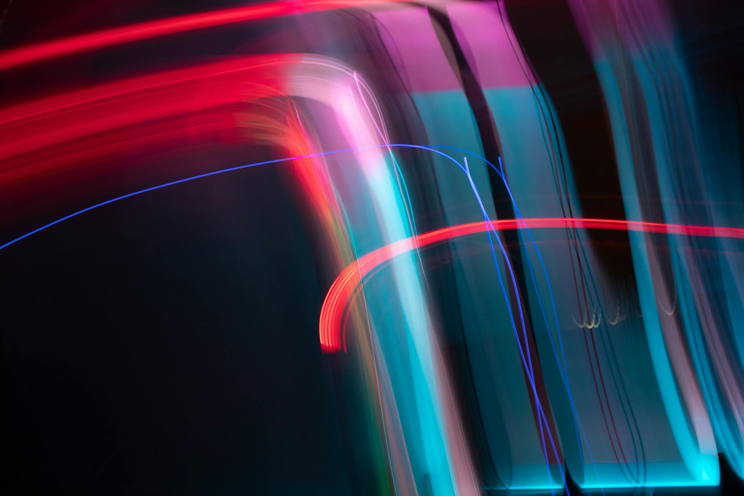 TabooTube Dynamic and colorful long exposure light streaks in an abstract artistic composition.