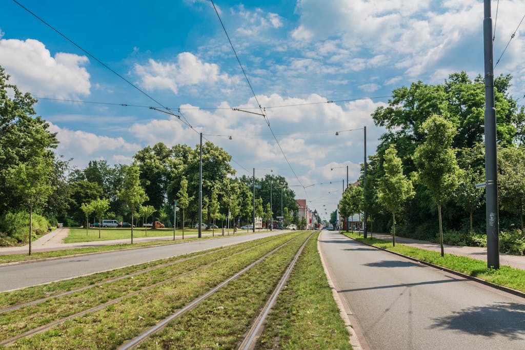 adsy.pw/hb5 Explore the serene urban sidewalks and tram tracks on a sunny day in Bremen, Germany.