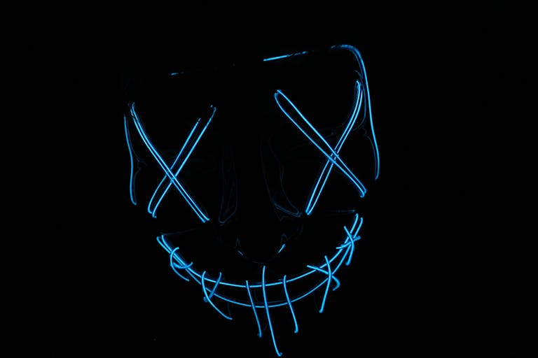 The Techno Tricks Futuristic neon blue LED mask glowing in the dark, ideal for tech and cyber themes.