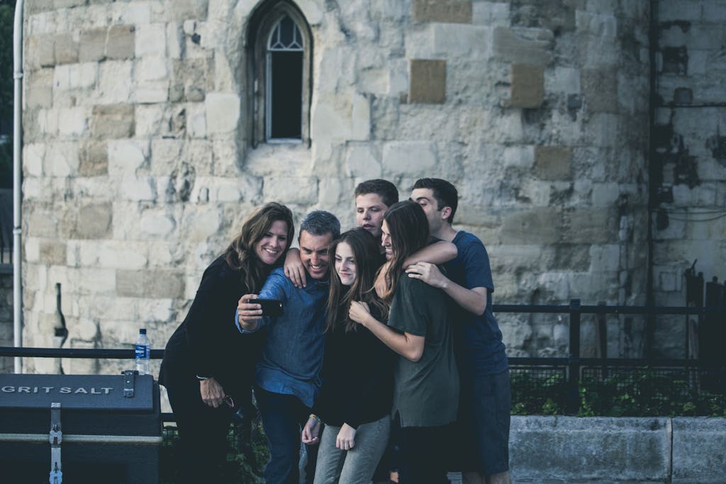 Gonzay Group of friends enjoying a moment together while taking a selfie outdoors.