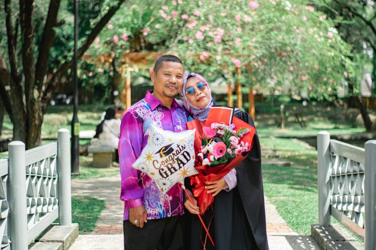 Acamento Happy moment captured of a couple celebrating a graduation in Shah Alam park, Malaysia.