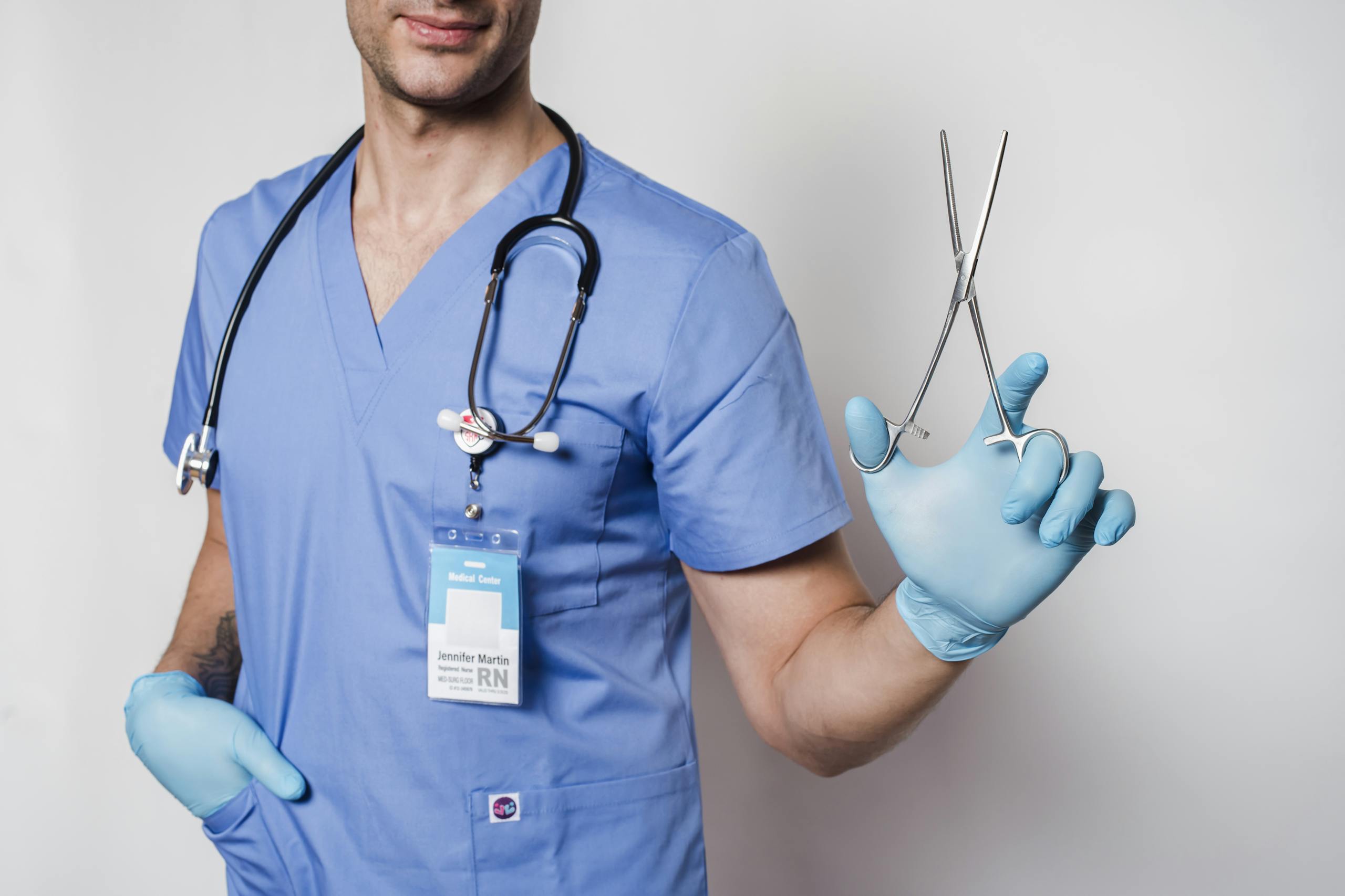 RN Fundamentals 2016 70 Questions Healthcare worker in scrubs holding forceps, symbolizing medical professionalism.