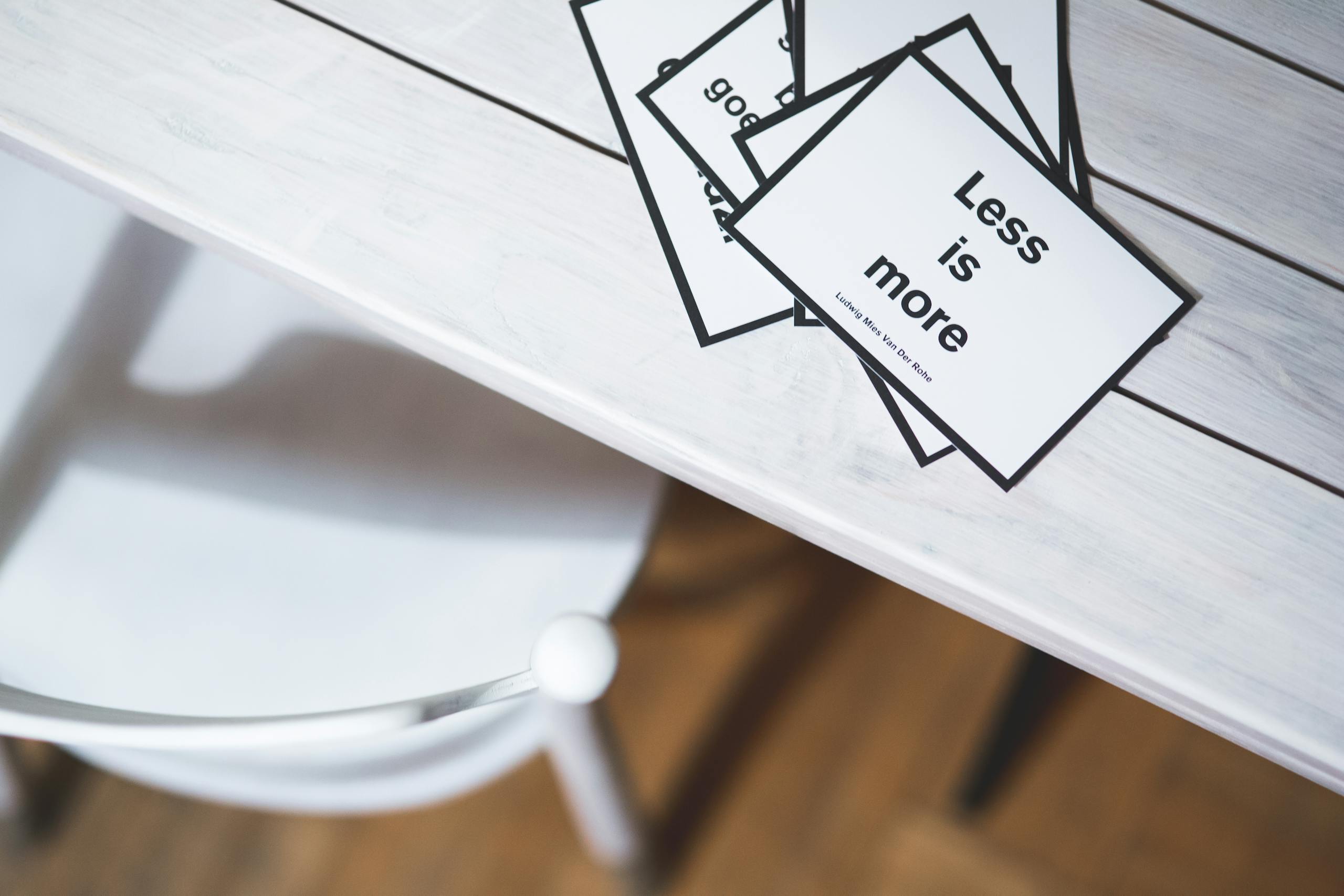 Sodiceram Minimalist black and white quote cards on a light wooden desk, perfect for design concepts.