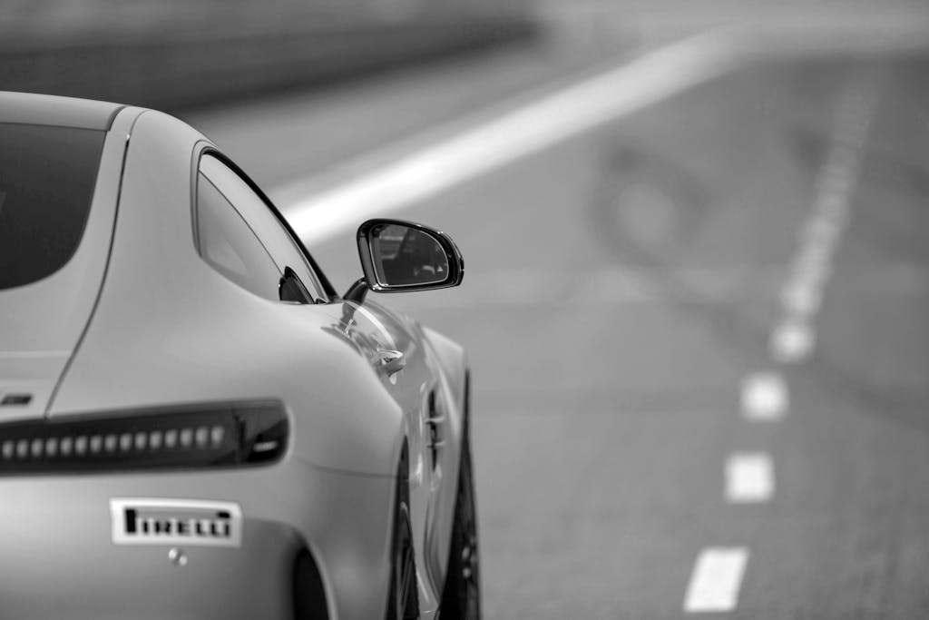 Witelovers Monochrome shot of a Mercedes-Benz showcasing elegance and speed on a Berlin road.