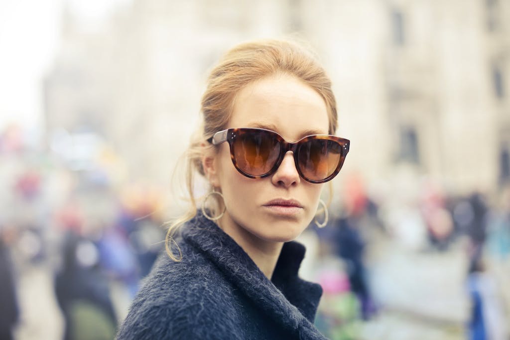 AC Milan vs SSC Bari Timeline Portrait of a fashionable woman wearing sunglasses in the vibrant streets of Milan, Italy.