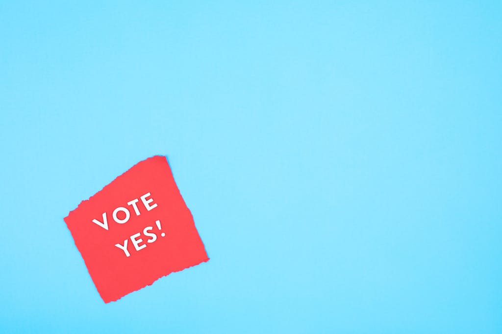 Simbramento Red paper with 'Vote Yes!' text on a bright blue background promoting positive political engagement.