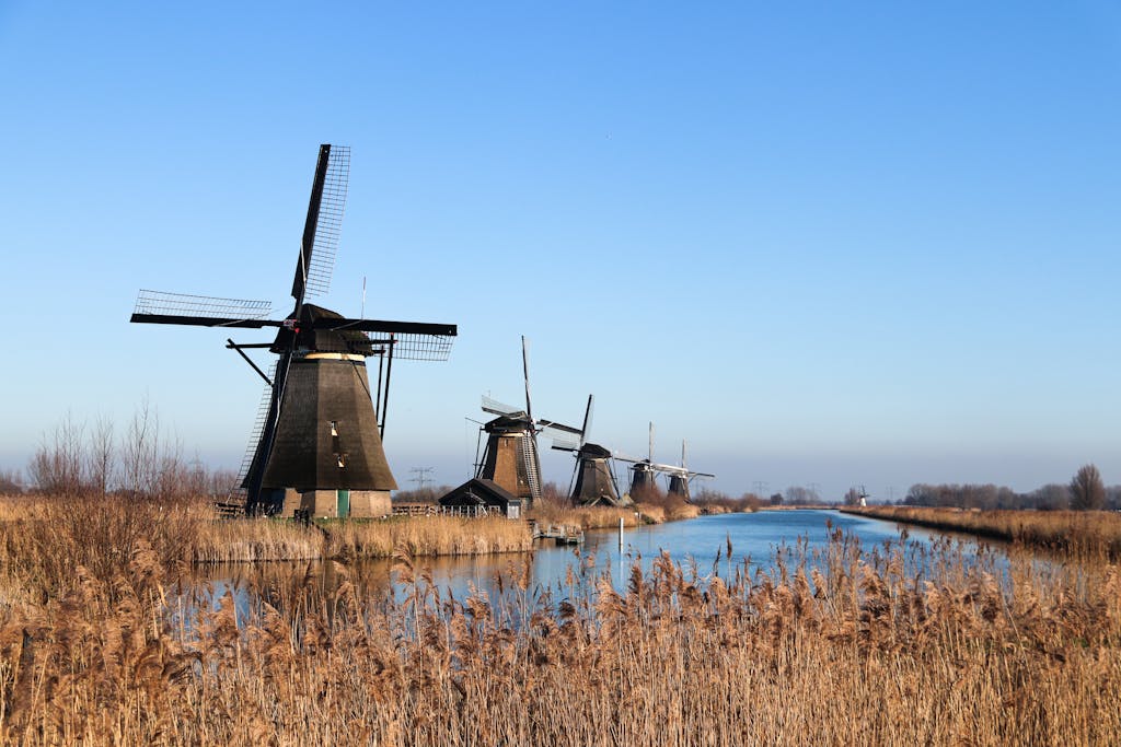 Trencher for Drainage Scenic view of historic windmills along a canal in Kinderdijk, Netherlands.