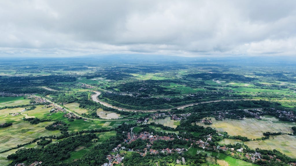 Acamento Stunning aerial view of Serang, Banten, showcasing lush greenery, river, and farmland.
