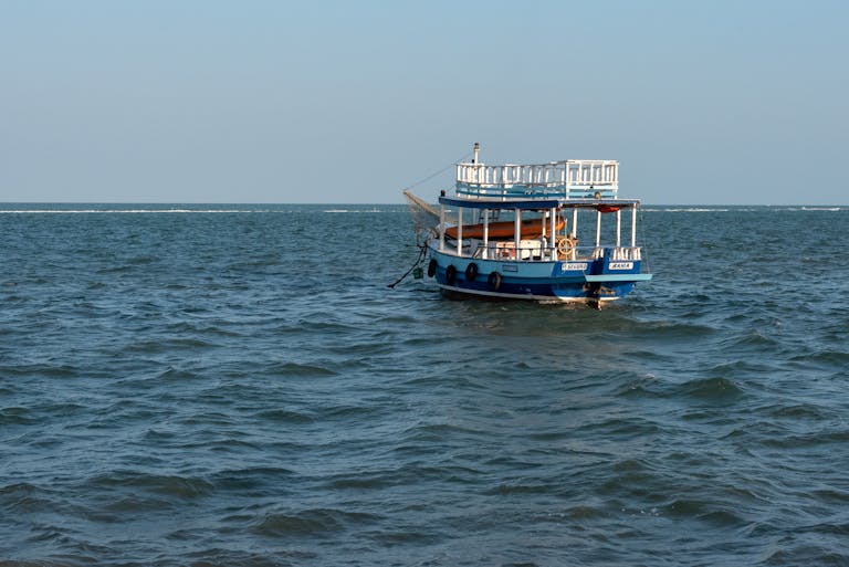 Juntos Seguros A tranquil boat floating on the blue waters of Porto Seguro, Brazil.