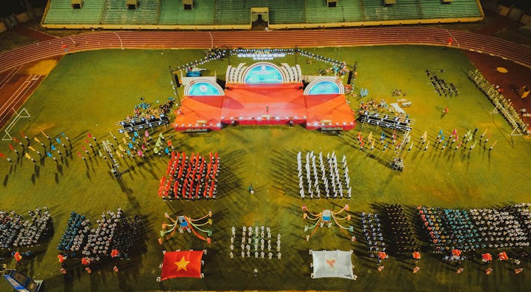 Messeregge A vibrant aerial shot of a sports event with organized groups and flags in a stadium.