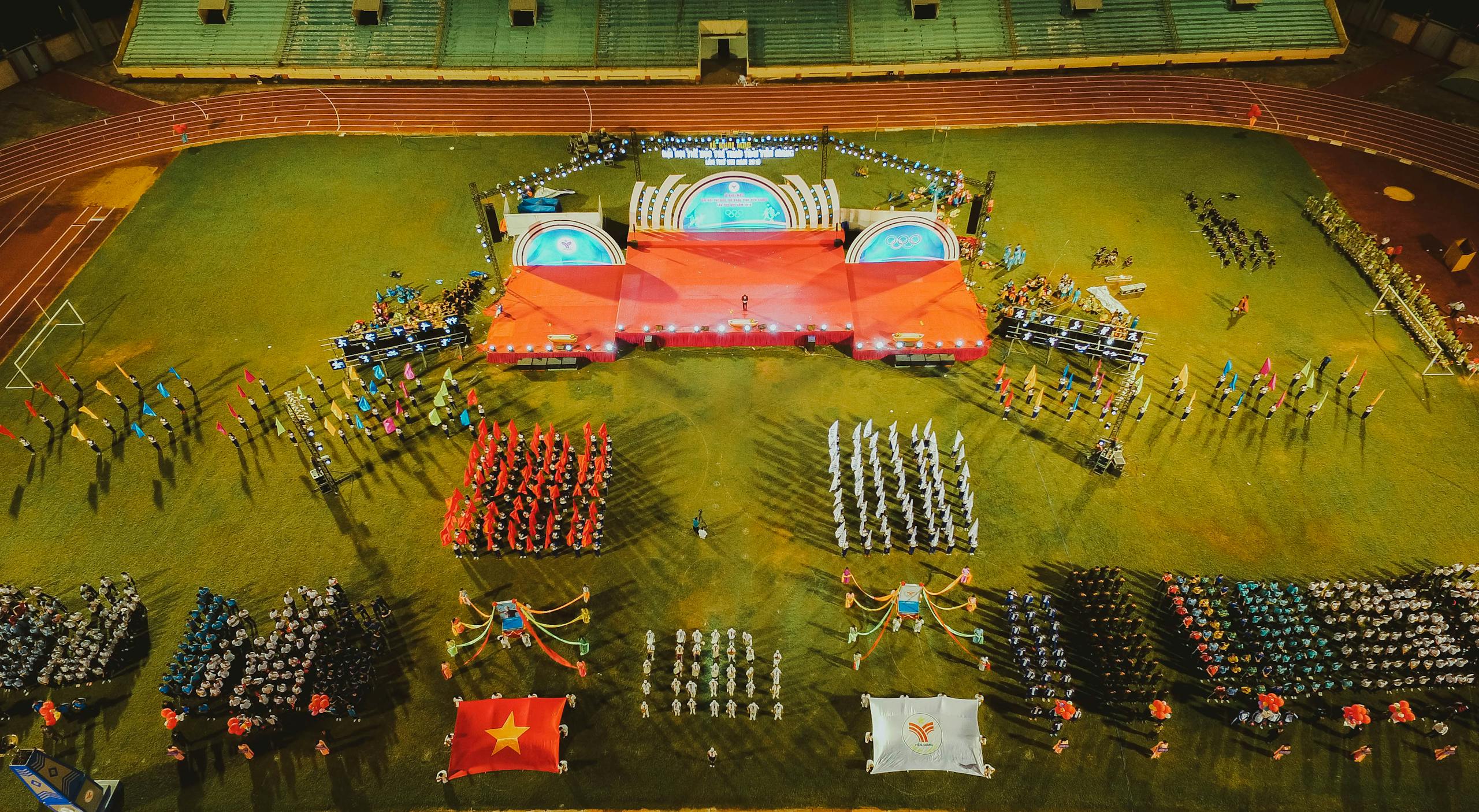 Messeregge A vibrant aerial shot of a sports event with organized groups and flags in a stadium.