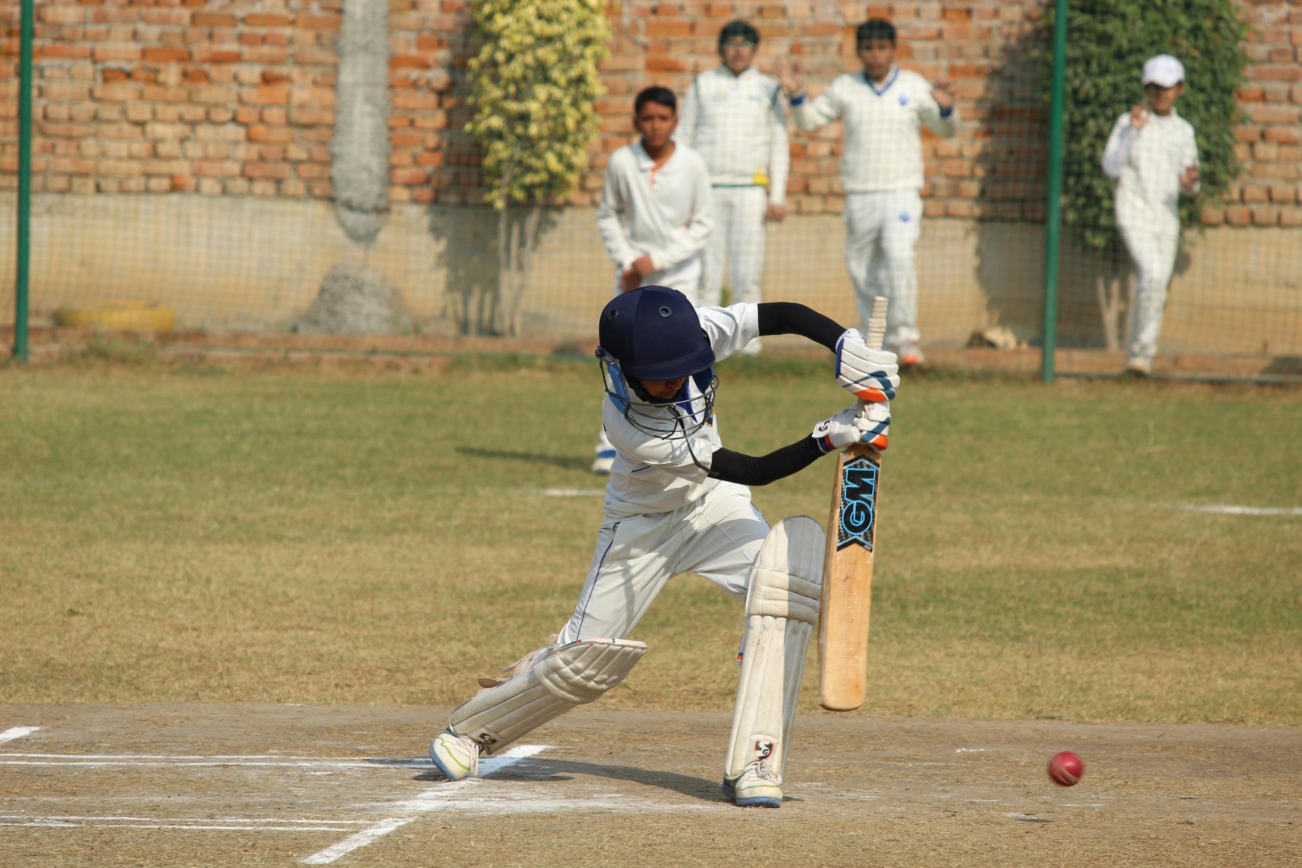 Pak vs Inda A young cricket player bats during a game on a sunny day in Gurugram, India.