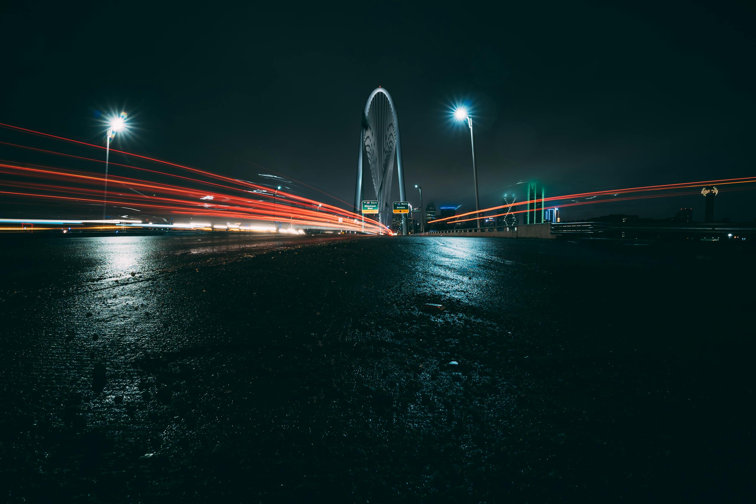 Texas Hunting Forum Dramatic long-exposure of Dallas bridge with car lights streaking under a night sky.