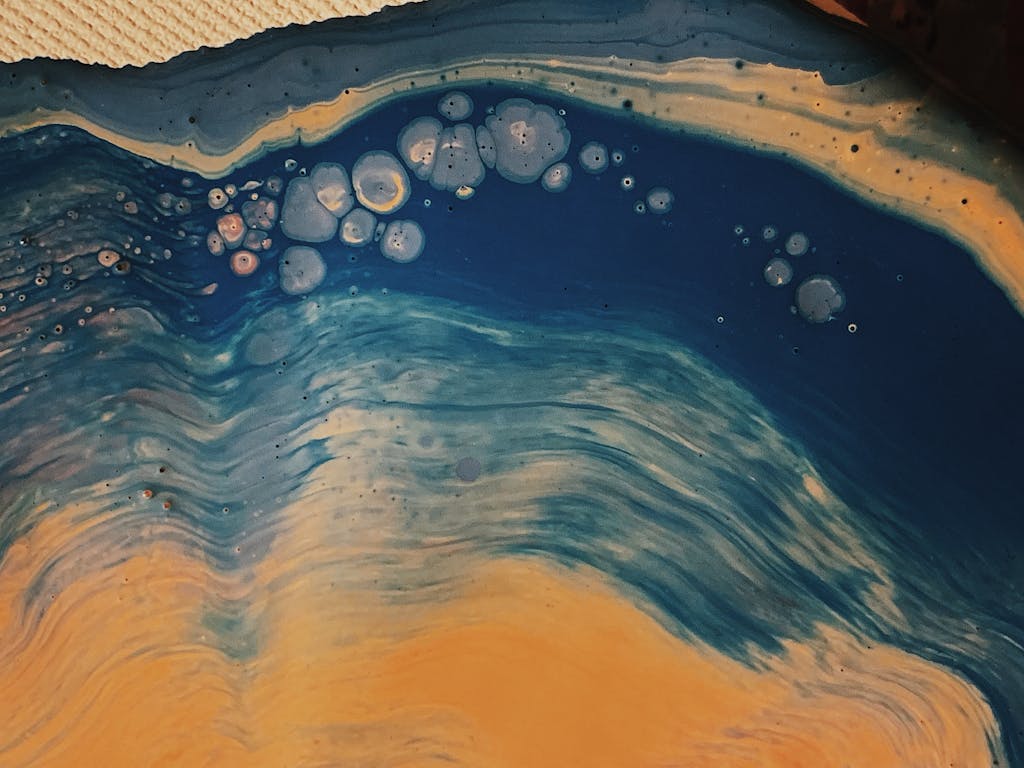 Redeepseek Engaging abstract fluid art painting in blue and yellow, showcasing dynamic movement and texture.