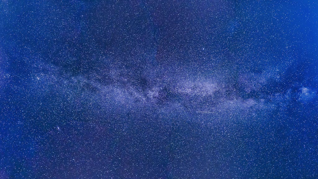 Voozon Stunning view of the Milky Way under a starry night sky, showcasing the universe's grandeur.