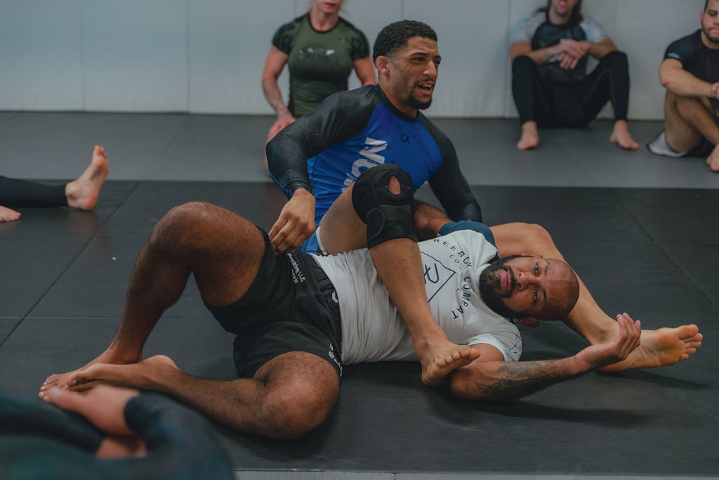 Trios 5 Invisalign Submission Two men engaged in a grappling training session at a martial arts gym, showcasing technique and focus.