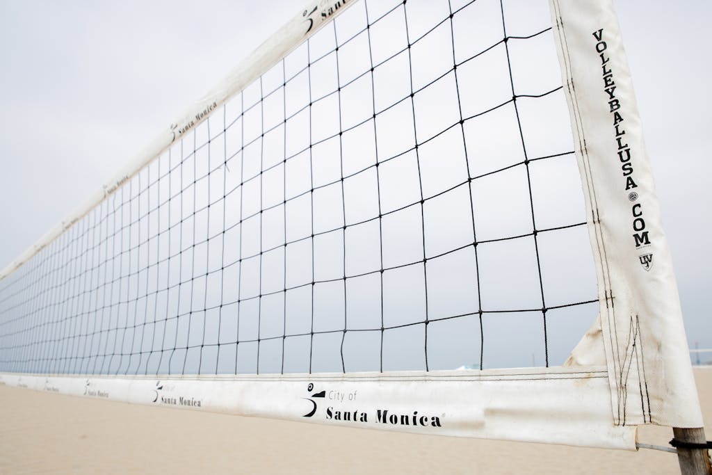 Cveb vatsap com lose-up of a volleyball net on Santa Monica beach, ideal for sports themes.