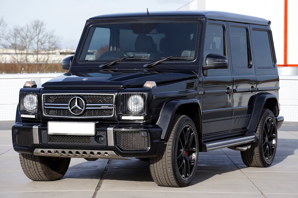  Unbanned G+ Stylish black Mercedes G-Class SUV parked outdoors. Perfect vehicle for off-roading and urban driving.
