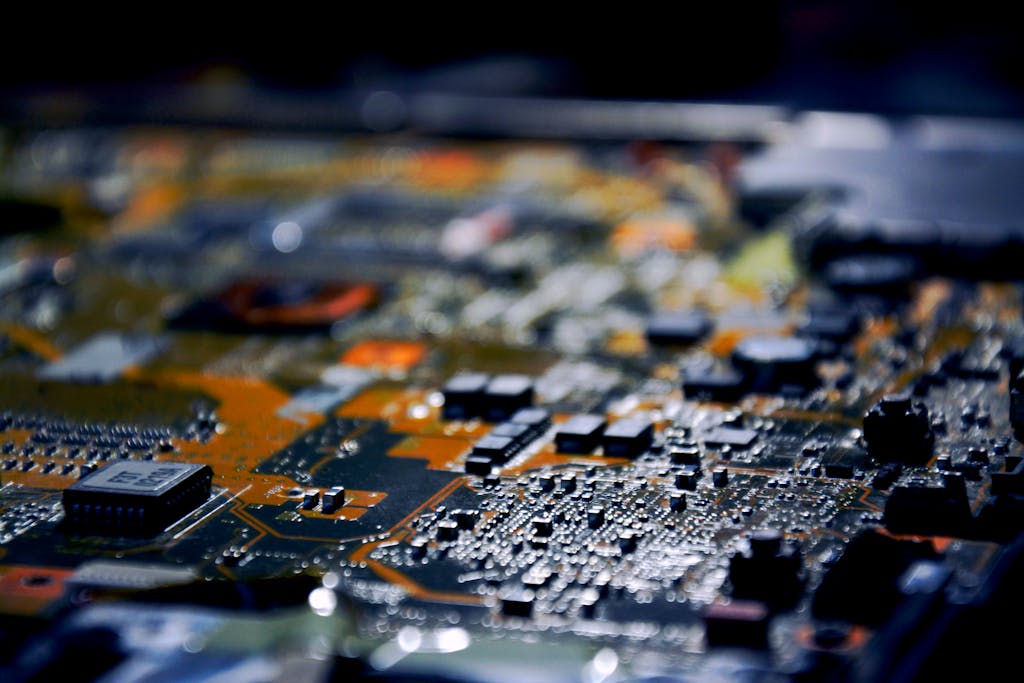 Kongotech.org Detailed close-up view of electronic circuit board, showcasing modern technology.